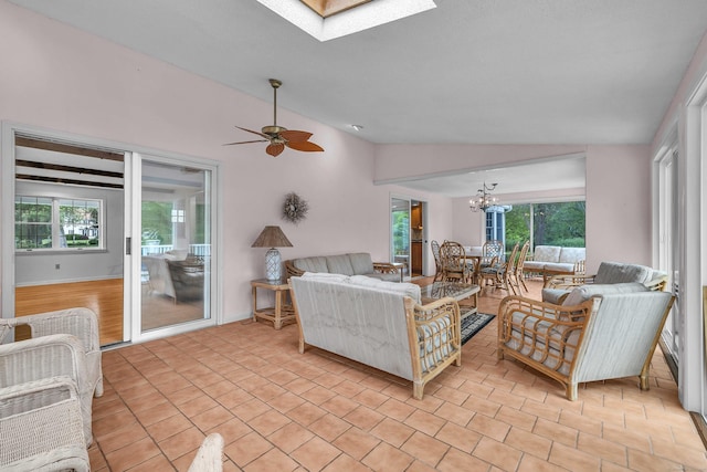 7 Sharon Ln, Old Saybrook, CT 06475 - living area with vaulted ceiling, healthy amount of natural light, a skylight, a chandelier, and a ceiling fan