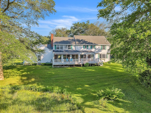 7 Sharon Ln, Old Saybrook, CT 06475 - back of house with a chimney, a deck, and a lawn