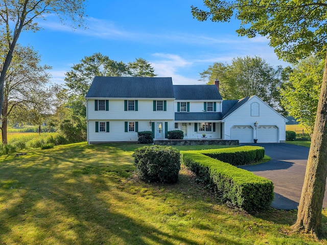 7 Sharon Ln, Old Saybrook, CT 06475 - view of front of property with a chimney, a garage, a front lawn, and driveway