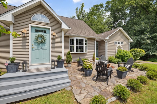 64 Red Top Dr, West Hartford, CT 06110 - view of front of home featuring a patio area, roof with shingles, and an outdoor fire pit