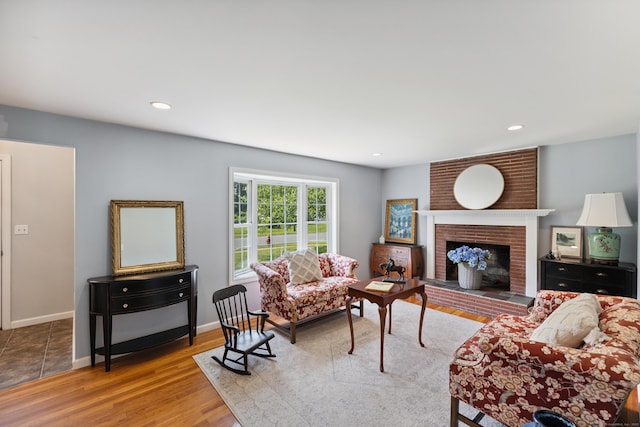 64 Red Top Dr, West Hartford, CT 06110 - living room featuring a brick fireplace, wood finished floors, and recessed lighting