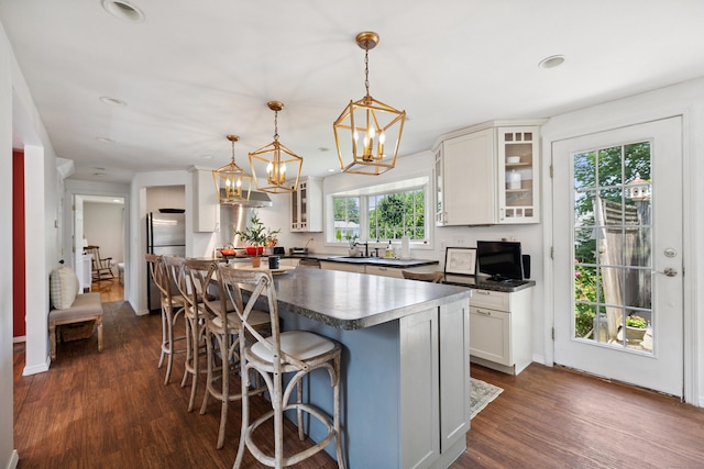 64 Red Top Dr, West Hartford, CT 06110 - kitchen featuring freestanding refrigerator, dark countertops, dark wood-style floors, white cabinets, and glass insert cabinets