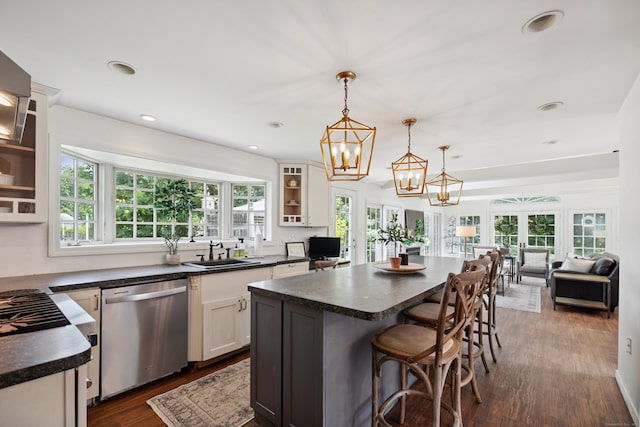 64 Red Top Dr, West Hartford, CT 06110 - kitchen with stainless steel dishwasher, dark countertops, a kitchen bar, glass insert cabinets, and a kitchen island