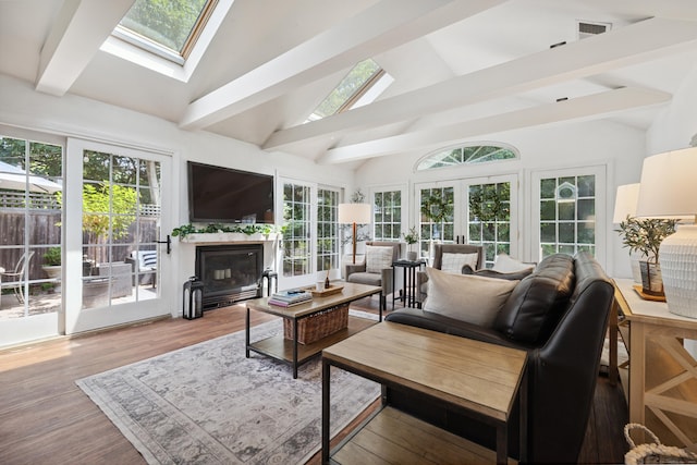64 Red Top Dr, West Hartford, CT 06110 - living room featuring a skylight, beam ceiling, a glass covered fireplace, french doors, and wood finished floors