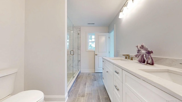 12 Woodland Dr, Milford, CT 06460 - bathroom featuring a shower stall, wood tiled floors, and double vanity