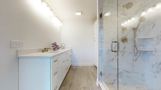 12 Woodland Dr, Milford, CT 06460 - full bathroom with a marble finish shower, double vanity, and wood tiled floors