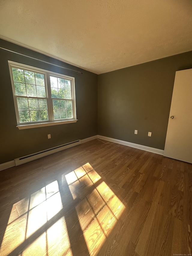 65 Horse Pond Rd Apt G, Salem, CT 06420 - empty room featuring baseboard heating, wood finished floors, and a textured ceiling