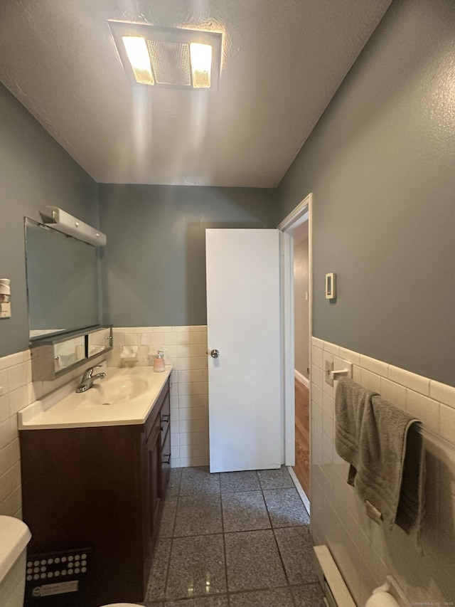 65 Horse Pond Rd Apt G, Salem, CT 06420 - bathroom featuring tile walls, a wainscoted wall, and vanity