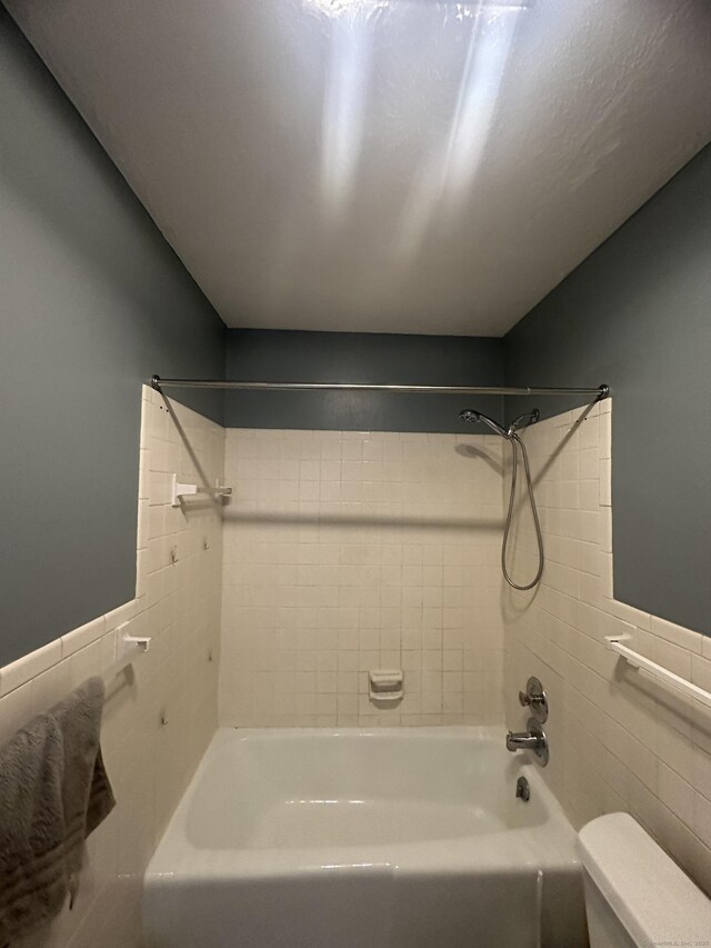 65 Horse Pond Rd Apt G, Salem, CT 06420 - bathroom with tile walls, bathing tub / shower combination, and wainscoting