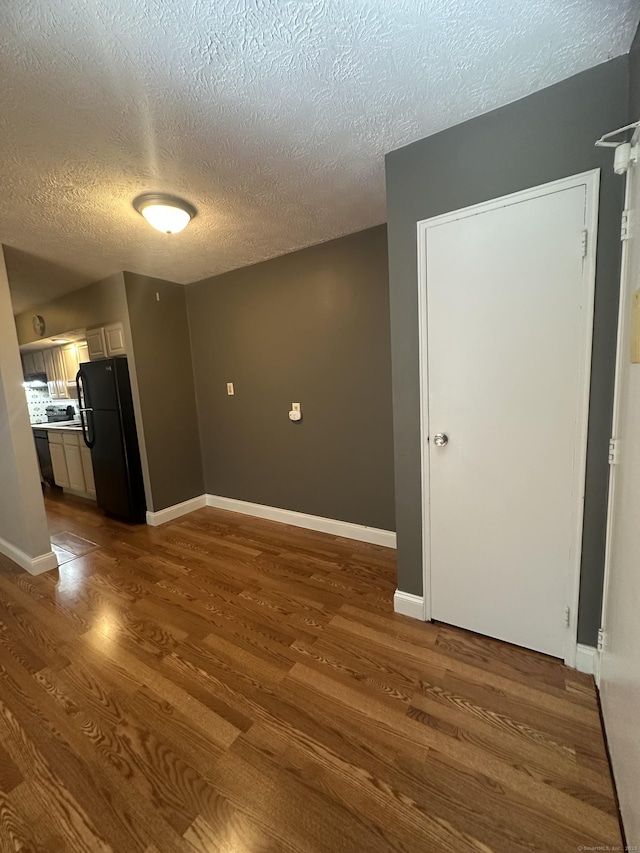 65 Horse Pond Rd Apt G, Salem, CT 06420 - unfurnished living room featuring dark wood-type flooring and a textured ceiling