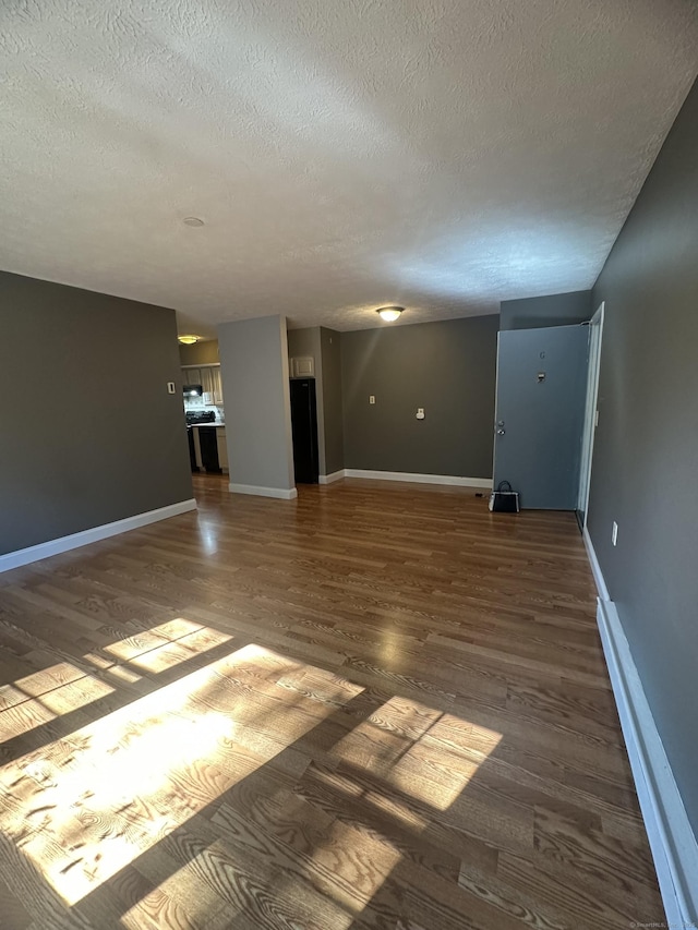 65 Horse Pond Rd Apt G, Salem, CT 06420 - unfurnished living room featuring a textured ceiling and wood finished floors