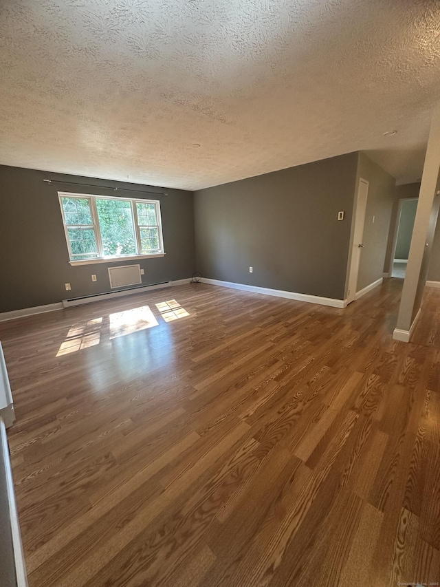65 Horse Pond Rd Apt G, Salem, CT 06420 - spare room featuring a textured ceiling, wood finished floors, and baseboard heating