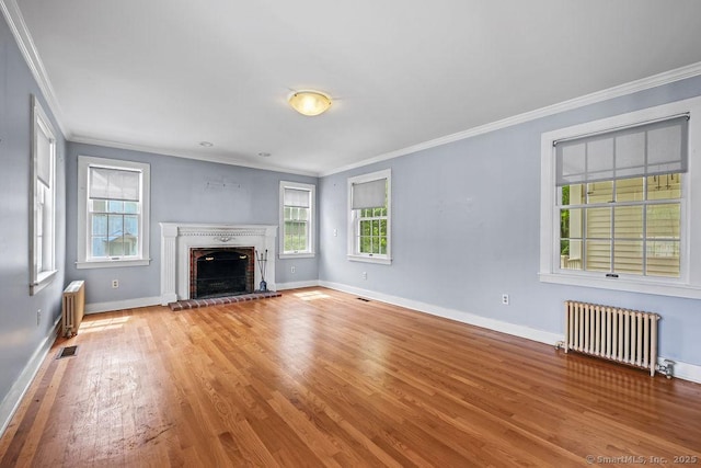 88 Powder Hill Rd, Middlefield, CT 06455 - unfurnished living room with radiator, wood finished floors, crown molding, and a brick fireplace