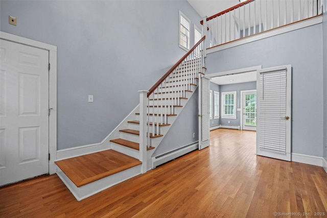88 Powder Hill Rd, Middlefield, CT 06455 - staircase with baseboard heating, a towering ceiling, and wood finished floors