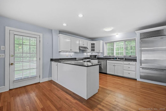 88 Powder Hill Rd, Middlefield, CT 06455 - kitchen with appliances with stainless steel finishes, under cabinet range hood, a peninsula, white cabinets, and recessed lighting