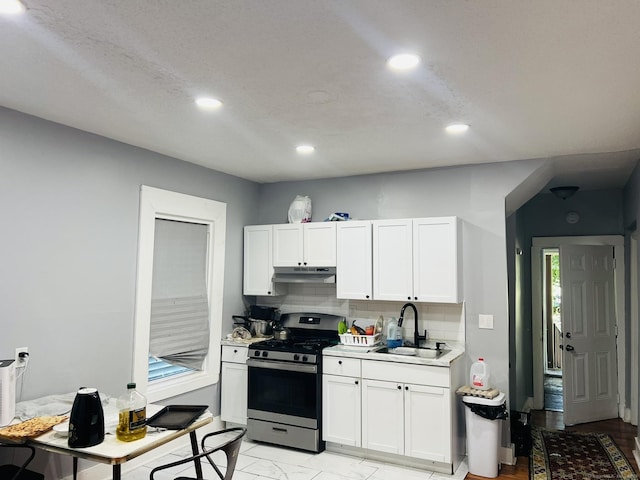 141 County St, New Haven, CT 06511 - kitchen with stainless steel range with gas cooktop, light countertops, tasteful backsplash, under cabinet range hood, and white cabinets