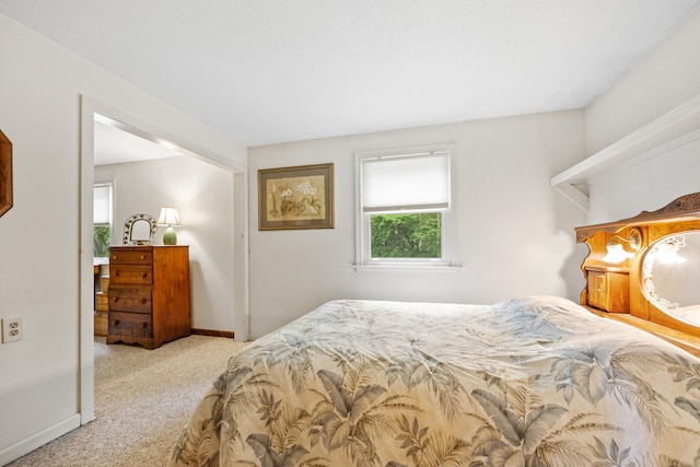carpeted bedroom with baseboards