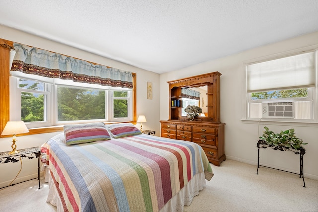 carpeted bedroom featuring cooling unit and baseboards