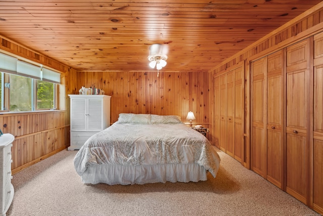 bedroom with light carpet, wood ceiling, and wooden walls