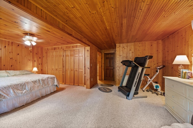 bedroom with wood walls, carpet, wooden ceiling, and a closet