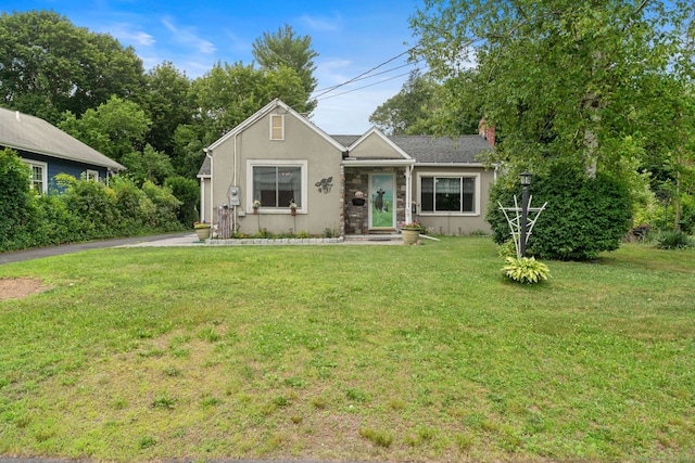 53 Columbus Ave, Bristol, CT 06010 - view of front of property featuring a front yard, stucco siding, and a chimney