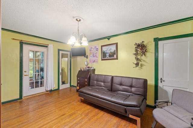 53 Columbus Ave, Bristol, CT 06010 - living area featuring a textured ceiling, a chandelier, and wood finished floors