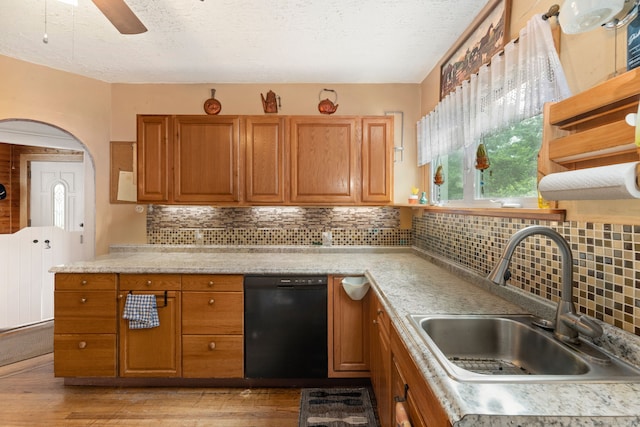 53 Columbus Ave, Bristol, CT 06010 - kitchen with black dishwasher, light countertops, brown cabinets, light wood-type flooring, and a textured ceiling