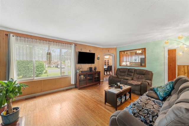 53 Columbus Ave, Bristol, CT 06010 - living area featuring arched walkways, hardwood / wood-style floors, and wooden walls