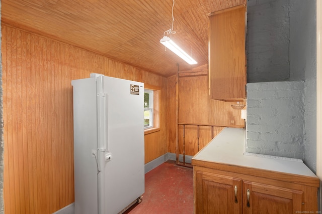 53 Columbus Ave, Bristol, CT 06010 - kitchen with freestanding refrigerator, light countertops, wood walls, concrete flooring, and wood ceiling