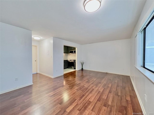 296 Main Ave Unit 1, Norwalk, CT 06851 - unfurnished living room with wood finished floors and a fireplace