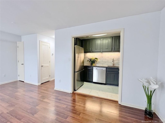 296 Main Ave Unit 1, Norwalk, CT 06851 - bar with appliances with stainless steel finishes, light wood-style flooring, and decorative backsplash