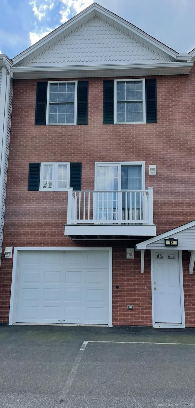 2 Fern Ave Apt 13, Wallingford, CT 06492 - view of front of home featuring an attached garage, driveway, brick siding, and a balcony