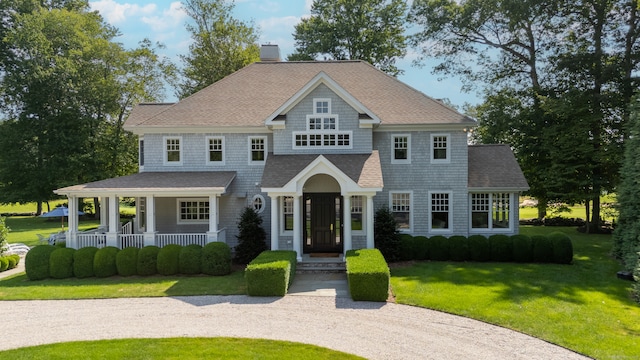 206 Fox Hopyard Rd, East Haddam, CT 06423 - shingle-style home featuring a front yard, a chimney, a porch, and roof with shingles
