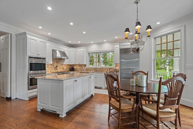 206 Fox Hopyard Rd, East Haddam, CT 06423 - kitchen featuring appliances with stainless steel finishes, a chandelier, ventilation hood, dark wood-type flooring, and crown molding