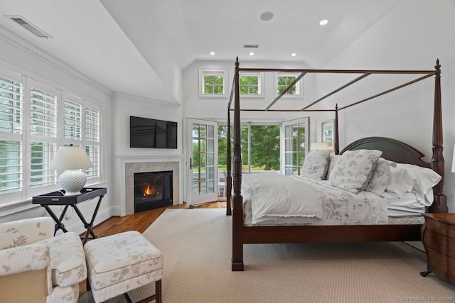 206 Fox Hopyard Rd, East Haddam, CT 06423 - bedroom with multiple windows, a glass covered fireplace, high vaulted ceiling, recessed lighting, and wood finished floors