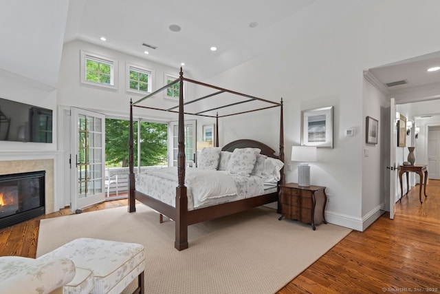 206 Fox Hopyard Rd, East Haddam, CT 06423 - bedroom with wood finished floors, a towering ceiling, access to outside, a fireplace, and recessed lighting