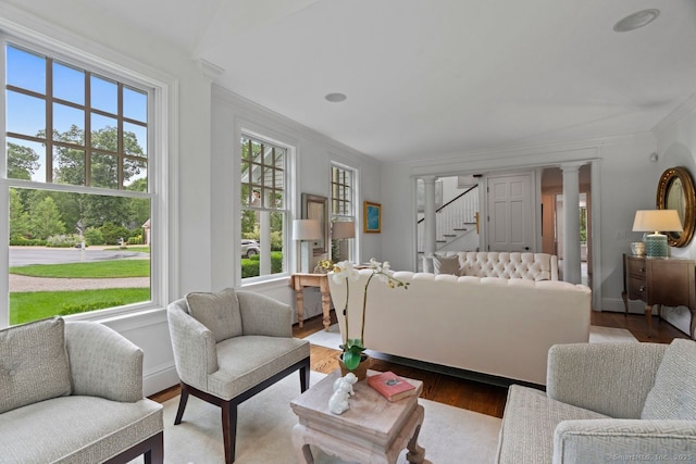 206 Fox Hopyard Rd, East Haddam, CT 06423 - living room featuring plenty of natural light, stairs, wood finished floors, crown molding, and ornate columns