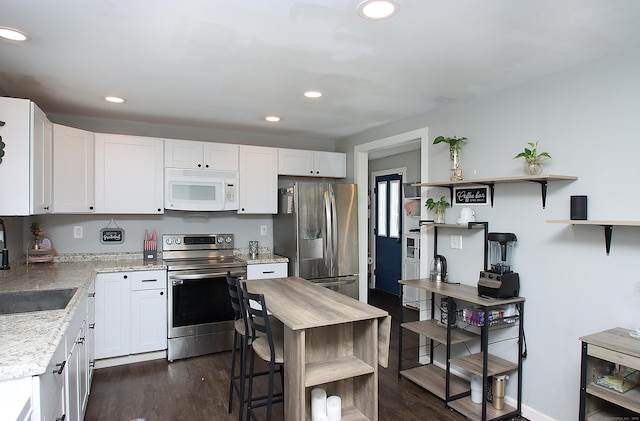 58 Litchfield St, Thomaston, CT 06787 - kitchen with stainless steel appliances, open shelves, white cabinetry, and recessed lighting