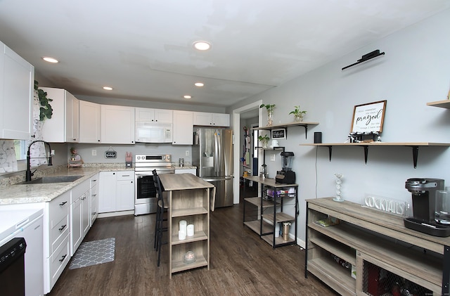 58 Litchfield St, Thomaston, CT 06787 - kitchen featuring open shelves, stainless steel appliances, white cabinetry, dark wood-style floors, and recessed lighting