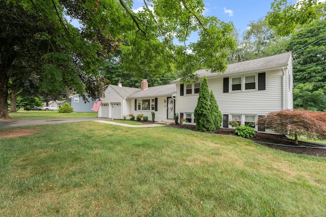 29 Jeffrey Dr, Wallingford, CT 06492 - split level home with a garage, a front lawn, driveway, a chimney, and roof with shingles
