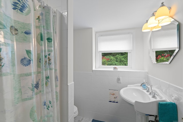 29 Jeffrey Dr, Wallingford, CT 06492 - bathroom with tile walls, a shower with shower curtain, and a wainscoted wall