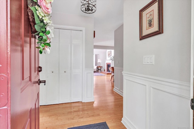 16 Juniper Cir Unit 16, Monroe, CT 06468 - foyer entrance featuring light wood-style flooring, a wainscoted wall, and a decorative wall