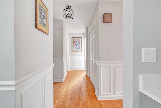 16 Juniper Cir Unit 16, Monroe, CT 06468 - hallway featuring a decorative wall, light wood-style floors, and wainscoting