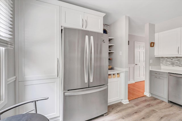 16 Juniper Cir Unit 16, Monroe, CT 06468 - kitchen featuring appliances with stainless steel finishes, light wood-type flooring, light countertops, and white cabinets