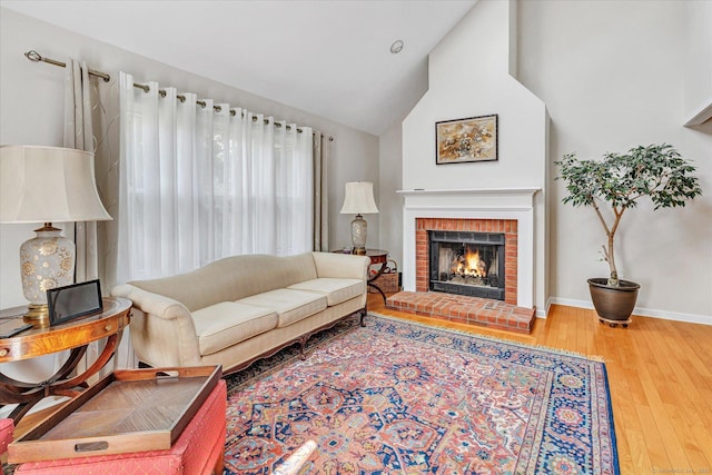 16 Juniper Cir Unit 16, Monroe, CT 06468 - living area featuring wood finished floors, a brick fireplace, and high vaulted ceiling