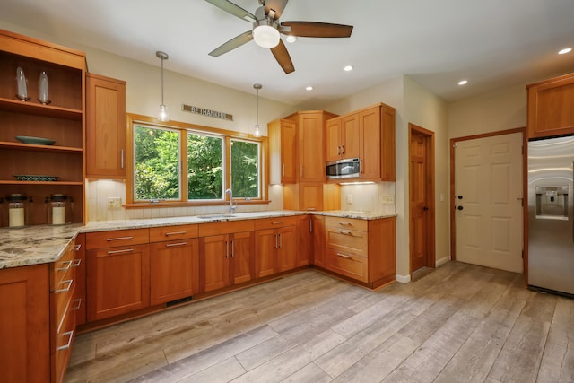 39 Beebe Rd, East Haddam, CT 06423 - kitchen featuring stainless steel appliances, a ceiling fan, tasteful backsplash, light stone counters, and light wood-type flooring