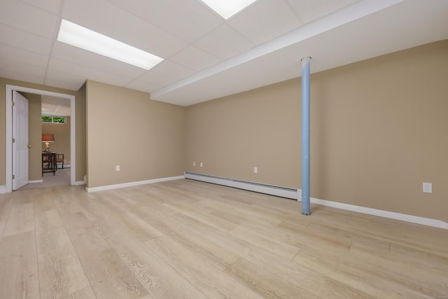 39 Beebe Rd, East Haddam, CT 06423 - finished below grade area featuring a baseboard radiator, light wood-style flooring, and a paneled ceiling