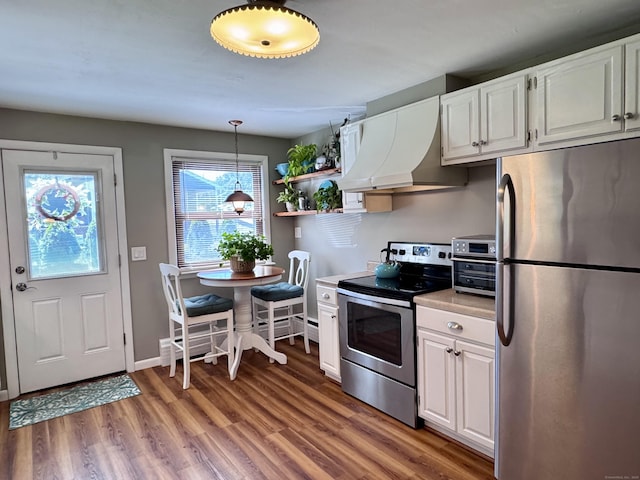44 Coolidge St, Windsor Locks, CT 06096 - kitchen with stainless steel appliances, extractor fan, light wood-style flooring, white cabinets, and light countertops