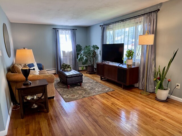 44 Coolidge St, Windsor Locks, CT 06096 - living room featuring hardwood / wood-style floors and a baseboard heating unit