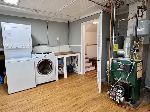 44 Coolidge St, Windsor Locks, CT 06096 - laundry area with stacked washing machine and dryer, wood finished floors, a heating unit, and water heater